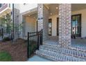 Charming brick front porch with brick detail and iron railing at 118 Iveybrooke Ln # 64, Alpharetta, GA 30009