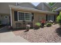 Cozy townhouse with a lovely front yard seating area, adorned with potted plants and mulched landscaping at 1468 Briarwood Ne Rd # 703, Atlanta, GA 30319
