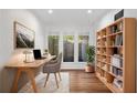Well-lit home office featuring a sleek desk, comfortable chair, and ample bookshelf space at 2784 Sixes Rd, Canton, GA 30114