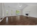 Spacious and airy living room featuring hardwood floors and a fireplace at 2990 Williams Farm Dr, Dacula, GA 30019