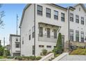 Beautiful townhome with landscaped front yard and charming curb appeal, featuring white siding and brick accents at 1780 Morningtide Ne Ln, Atlanta, GA 30324