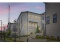 Beautiful townhome with landscaped front yard and charming curb appeal, featuring white siding and brick accents at 1780 Morningtide Ne Ln, Atlanta, GA 30324