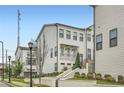 Beautiful townhome with landscaped front yard and charming curb appeal, featuring white siding and brick accents at 1780 Morningtide Ne Ln, Atlanta, GA 30324