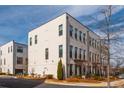 Corner unit townhome featuring a painted brick facade and professional landscaping at 472 Burton Dr, Alpharetta, GA 30009