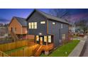 View of the backyard featuring a wooden deck, privacy fence, and well-maintained lawn at 701 Smith St, Atlanta, GA 30310