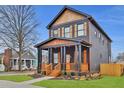 Charming two-story home with a inviting front porch and beautiful wood accents and well-maintained lawn at 701 Smith St, Atlanta, GA 30310