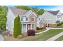 Well-kept home showcases a brick and siding exterior, complemented by lush landscaping and a paved walkway at 120 Generals Pl, Canton, GA 30114