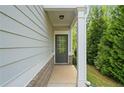 Inviting front entrance of home with modern door, white pillars, and fresh landscaping at 235 Centennial Cir, Canton, GA 30114