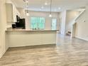 Spacious kitchen featuring a breakfast bar, modern pendant lighting, and an adjacent dining area at 235 Centennial Cir, Canton, GA 30114