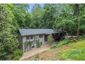 Beautiful two-story home featuring lush landscaping, trees, and well-maintained exterior at 2361 Woodward Nw Way, Atlanta, GA 30305