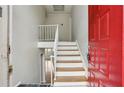 Bright entryway featuring fresh paint, wooden stairs with white rails, and a red door at 3344 Northcrest Rd # A, Atlanta, GA 30340