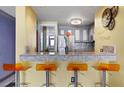 Kitchen with bar seating, stainless appliances, granite countertops and modern lighting at 375 Ralph Mcgill Blvd # 1503, Atlanta, GA 30312