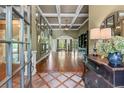 Grand foyer showcasing coffered ceilings, hardwood floors, decorative mirrors, and an open floor plan at 2111 Democracy Dr, Buford, GA 30519