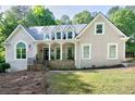 Charming home featuring a welcoming front porch, stone accents, and well-manicured lawn and manicured lawn at 436 Westlake Nw Dr, Marietta, GA 30064