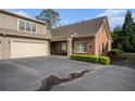Charming home featuring a brick facade, attached garage and driveway at 156 Kendrick Farm Ln, Marietta, GA 30066