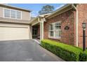 Home featuring a brick facade, attached garage and well manicured bushes at 156 Kendrick Farm Ln, Marietta, GA 30066