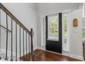 Hardwood floors lead to a black front door with sidelights, offering a bright and welcoming space at 1205 Campbell Ridge Ln, Lawrenceville, GA 30045