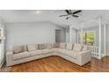 Spacious living room featuring hardwood floors and a large sectional sofa at 204 Holly Creek Way, Woodstock, GA 30188