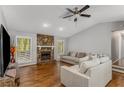 Bright and airy living room with a stone fireplace and hardwood floors at 204 Holly Creek Way, Woodstock, GA 30188