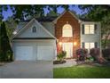 Charming two-story home featuring a two-car garage, brick accents, manicured lawn and beautiful shrubbery at 2264 Howell Farms Nw Trl, Acworth, GA 30101