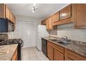 Functional kitchen with appliances, tile flooring, laminate countertops, and ample cabinet space at 2308 Country Park Se Dr, Smyrna, GA 30080