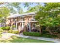 Charming brick townhome with well-maintained landscaping, balcony, and outdoor seating area at 1634 Ponce De Leon Ne Ave # 506, Atlanta, GA 30307