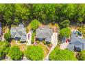 Aerial view of a brick home featuring a circular driveway, mature landscaping, and an in-ground pool at 2644 Nutwood Trce, Duluth, GA 30097