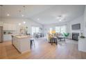 Bright, open-concept living space with hardwood floors, neutral decor, and a cozy fireplace at 1411 Stephens View Dr, Loganville, GA 30052