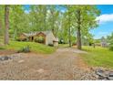 View of home with brick facade and basketball court on a spacious lot at 151 Mark Se Ln, Smyrna, GA 30082