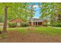 Traditional-style home with a brick facade, complemented by lush landscaping at 151 Mark Se Ln, Smyrna, GA 30082