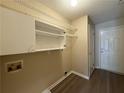 Functional laundry room area with storage shelves and convenient access to an exterior door at 16 Grandview Ct, Powder Springs, GA 30127