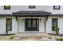 Elegant front door featuring glass inserts, flanked by windows and set against a charming brick facade at 3270 Brookview Dr, Marietta, GA 30068