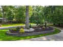 Meticulously maintained landscaping with stone accents and lush greenery surrounding a mature tree in the front yard at 3270 Brookview Dr, Marietta, GA 30068