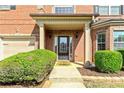 Inviting front entrance with lush landscaping leading to a classic black front door and covered porch at 532 Pelham Pl, Mcdonough, GA 30253