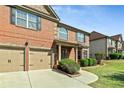 Attractive brick home with a two-car garage, well-kept landscaping, and a covered front entrance at 532 Pelham Pl, Mcdonough, GA 30253