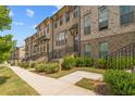 Brick townhome exterior with manicured landscaping and private entries at 613 Harrington Hls, Decatur, GA 30032