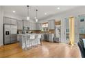 Modern kitchen features stainless steel appliances and hardwood floors at 613 Harrington Hls, Decatur, GA 30032