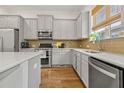 Stylish kitchen showcasing white cabinets, stone countertops, and hardwood floors at 613 Harrington Hls, Decatur, GA 30032