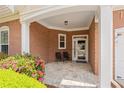 Charming brick front porch with seating area and well-maintained landscaping at 6355 Marlow Dr, Cumming, GA 30041