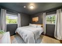 Cozy bedroom with neutral walls, natural light from two windows, and soft textures, offering a peaceful retreat at 2079 Nancy Se Cir, Smyrna, GA 30080