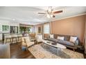 Inviting open concept living room featuring hardwood floors, neutral color palette and seamless flow to the kitchen and dining area at 2079 Nancy Se Cir, Smyrna, GA 30080