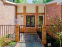 Inviting front entrance with brick surround, iron gate, and well-maintained landscaping at 3290 Custer Lake Nw Dr, Marietta, GA 30064