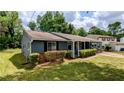 Charming single-story home with blue siding, a well-maintained lawn, and a cozy covered front porch at 5266 Long Green Ln, Stone Mountain, GA 30088