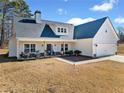 Charming home featuring a modern design with a welcoming front porch and well-manicured landscaping at 104 Federal Path, Temple, GA 30179