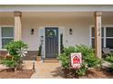 Close-up of home's welcoming entrance with decorated front door and stone accents at 104 Federal Path, Temple, GA 30179