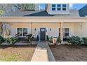Inviting front porch featuring rocking chairs, stylish decor, and well-maintained landscaping at 104 Federal Path, Temple, GA 30179