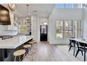 Open concept kitchen with a large island, stainless appliances, and dining area with high ceilings at 11189 Serenbe Ln, Chattahoochee Hills, GA 30268