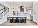 Modern kitchen features stainless steel appliances, white cabinets, and a large island with bar seating at 11189 Serenbe Ln, Chattahoochee Hills, GA 30268