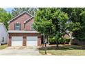 Beautiful two-story brick home with a well-maintained front yard and mature trees at 1780 Spring Hill Cv, Lithonia, GA 30058