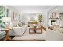 Bright living room with white walls, fireplace, hardwood floors, and stylish neutral furniture at 3932 Granger Dr, Brookhaven, GA 30341